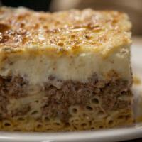 Pastitsio · Traditional baked pasta with ground beef and béchamel sauce.