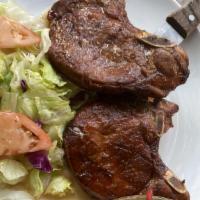 Pork Chops · Premium marinated pork chop fried and served with choice of side.