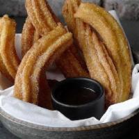 Churros · With chocolate dipping sauce.