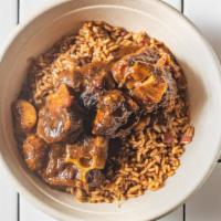 Oxtail Stew · Served with rice and peas.
