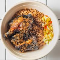 Jerk Chicken · Served with rice, peas, and pineapple salsa.