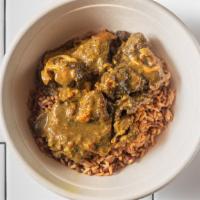 Curry Goat · Served with rice and peas.