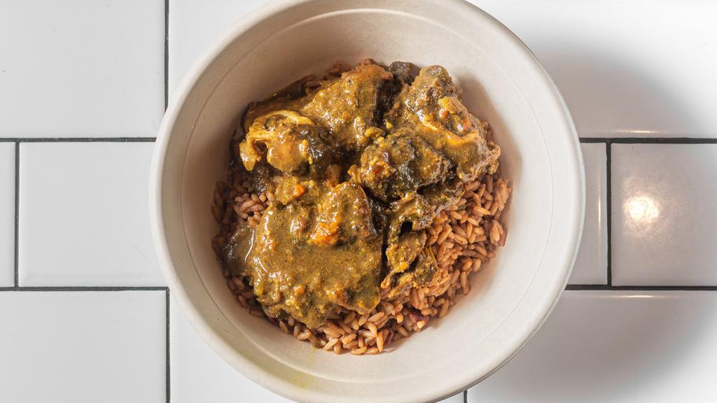 Curry Goat · Served with rice and peas.