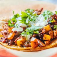 Al Pastor Taco · Pork marinated in a blend of dried chilis, spices, pineapple and achiote.