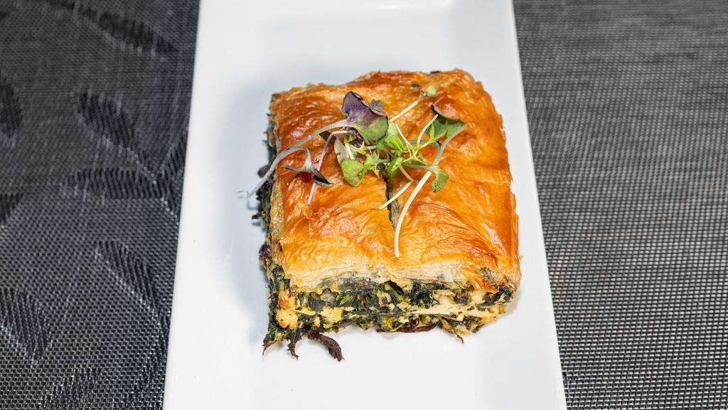 Spanakopita · A classic dish of spinach, Feta, leeks, dill, and onions baked in puff phyllo dough.