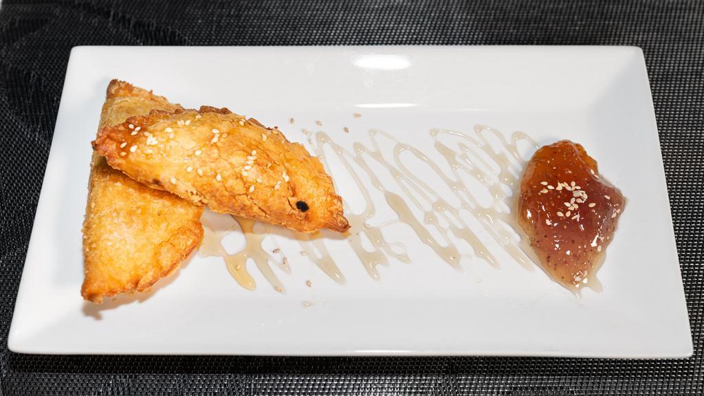 Feta Me Meli · Baked feta wrapped in phyllo dough topped with sesame seeds, honey, and fig jam.