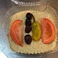 Hummus · Chickpeas blended with tahini, garlic and seasoning, garnished with olives, peppers, tomatoe...