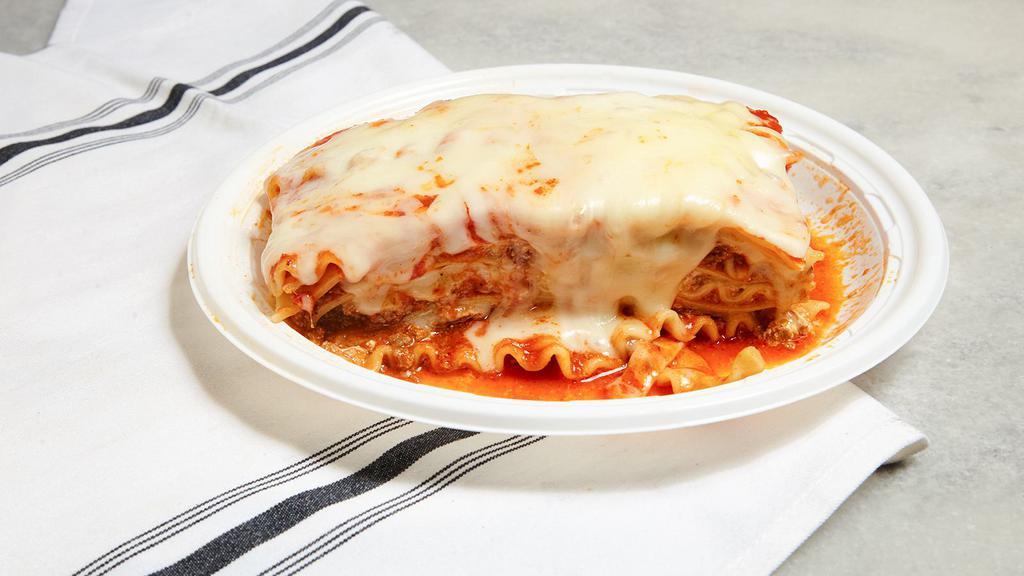 Lasagna · Layers of pasta with fresh ground beef ricotta parmesan and mozzarella cheeses in our own tomato sauce.