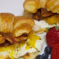 Bacon, Egg And Cheese Sandwich · Naturally smoked bacon, fluffy eggs and melted American cheese on a toasted flaky croissant.