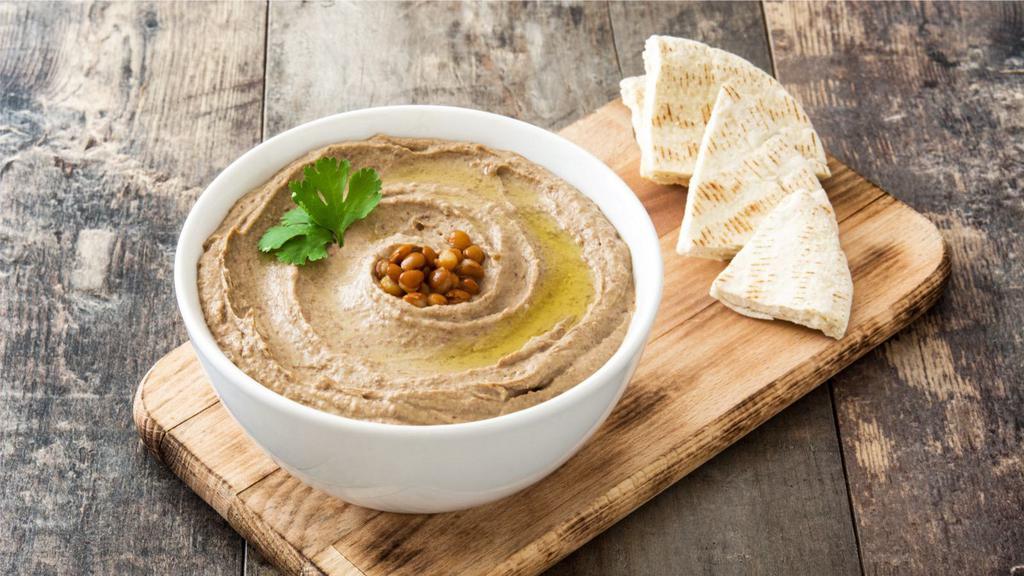 Hummus With Pita · Garbanzo beans blended with fresh garlic, fresh lemon juice and tahini sauce, topped with organic extra virgin olive oil and served with warm pita.