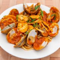 Mix Seafood Pasta  · clams mussels shrimp and camari sauteed with fresh garlic white wine and basil over pasta