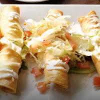 Carne Asada Flautas · 4 pieces. Served with rice & beans.