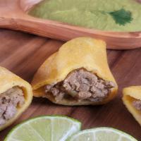Beef Empanada · Beef Empanadas are made by folding corn dough over a filling into a half-moon shape and eith...