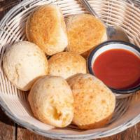Pao De Queijo · Gluten free house made cheese bread served with our house guava jam.