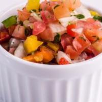 Diced Tomato Salsa · Diced tomato salsa with onions, bell-pepper, cilantro and parsley.