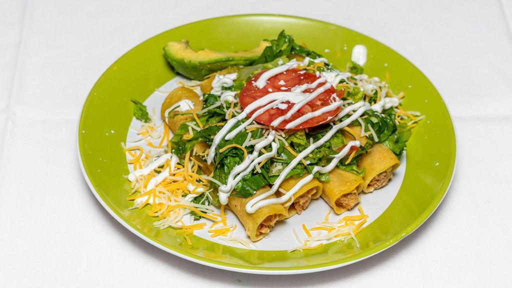 Flautas
 · (4) Crunchy corn tortilla chicken tacos topped with lettuce, tomato, sour cream and cheese. Served with rice and beans.
