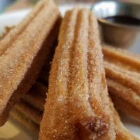 Caramel Stuffed Churros · 6 five in churros stuffed with caramel coated in cinnamon sugar. Served Chocolate dipping sa...