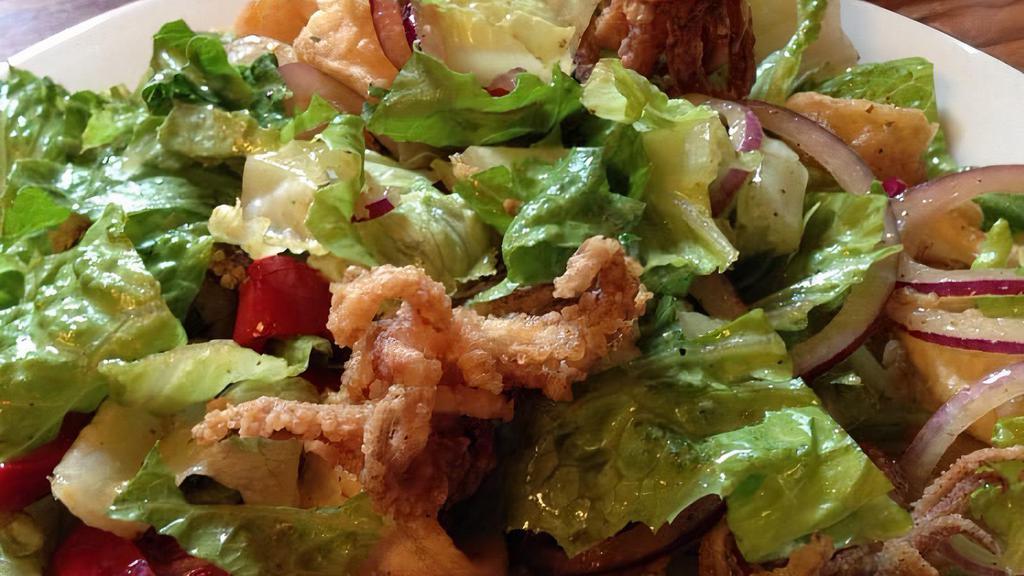 Crispy Calamari Salad · Crispy calamari, red onions, banana peppers and romaine lettuce, served with lemon vinaigrette.