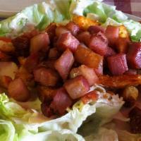 Iceberg Wedge Salad · A wedge of iceberg topped with bacon, tomatoes and croutons, served with homemade blue chees...