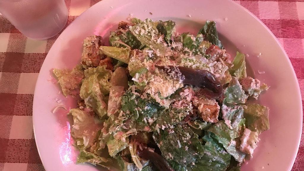 Classic Caesar Salad · Romaine lettuce with Caesar dressing and croutons, topped with anchovies.