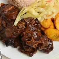 Oxtail · A hearty and flavorful Braised oxtail with butter beans, marinated with allspice, garlic, th...