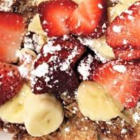 French Toast · Served with butter, syrup, light powdered sugar, with 3 eggs and choice of meat