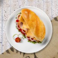 Vegan Deli Slice Sandwich · Tofurky deli slices, lettuce, tomato, vegan mayo, and Follow Your Heart cheese served on a b...