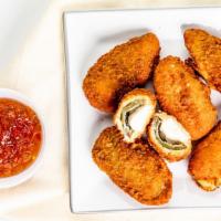 Jalapeno Poppers · Jalapenos seeded and stuffed w/smooth rich cheddar cheese served w/sour cream.