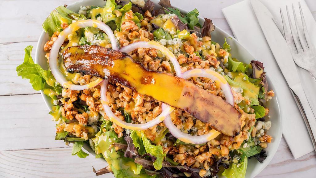 Arcadian Salad · Arcadian mix salad - Arcadian mix, candied walnuts, crumbled gorgonzola tossed in our homemade apricot vinaigrette, topped with red onions and applewood smoked bacon.