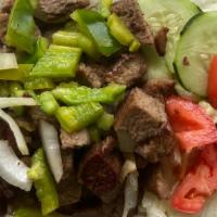 Lamb Over Rice · Grilled lamb with sauteed onions and green peppers on top of rice, salad lettuce, tomato, cu...