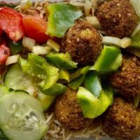 Falafel Over Rice · 5 falafel balls with sauteed onions and green peppers on top of rice, salad lettuce, tomato,...