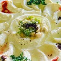 Hummus · Chickpeas mashed with tahini, garlic, lemon juice and olive oil. Served with fresh baked pit...
