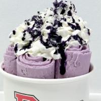 Ooh Bae · Ube flavored Ice Cream topped with whipped cream, coconut flakes, and Ube drizzle.