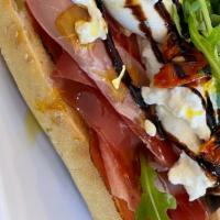 Speck & Burrata Hero · Thinly sliced Burrata, Arugula, roasted tomato, balsamic glaze & chunks of Grana Padano