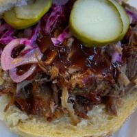 Bbq Brisket On Roll · Served on bun. Slow roasted dry rubbed brisket with slaw, pickle onions, and BBQ sauce.