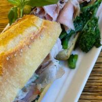 Porchetta & Rabe Hero · Served on seeded hero. Sliced roasted herbed pork with rabe, pesto, cherry peppers, and your...