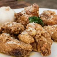 The Garlic Parmesan Wings · Garlic butter and parmesan cheese smothered over oven-baked crispy chicken wings.