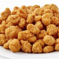 30 Pc Popcorn Chicken Combo · Small chicken in the shape of a popcorn. Includes french fries and a free can soda.