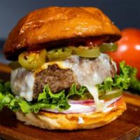 Glory Glory Jalapeño Burger · American beef patty topped with melted pepper jack cheese & spicy jalapenos. Served on class...