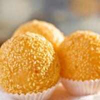 Sesame Seed Mochi Ball 炸煎堆 · Deep-fried sweet mochi ball coated in sesame seeds and filled with thick, sweet red bean pas...