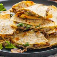 Mushroom Quesadilla · Roasted mushrooms and shredded melted cheese in a crispy flour tortilla and served with a si...