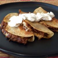 Chicken Mole Quesadilla · Chicken in a mole sauce and shredded melted cheese in a crispy flour tortilla and served wit...