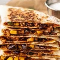 Corn And Black Bean Quesadilla · Corn, black beans, and shredded melted cheese in a crispy flour tortilla and served with a s...