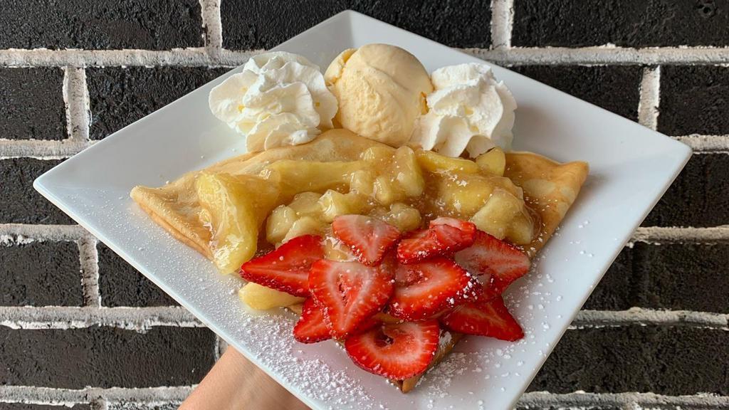 Apple Cobbler Crêpe · Like Apple Pie?  You’ll love this!  Comes stuffed with apple filling, cinnamon-apple pieces, and slices of fresh strawberries.  Comes topped with whipped cream and one scoop of either vanilla, chocolate, or strawberry ice cream!