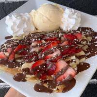 Nutella, Strawberry & Banana Crêpe · Fresh strawberry, banana slices and rich Nutella® top off this crepe.  Comes topped with whi...