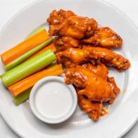Spicy Buffalo Wings · Served with blue cheese dressing, carrots and celery.