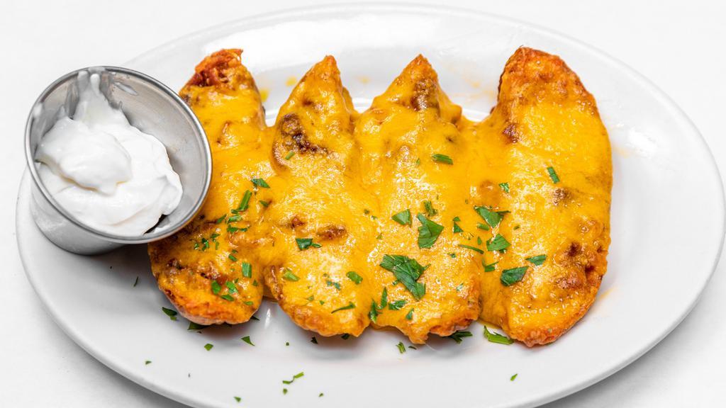 Idaho Potato Skins · Served with cheddar and bacon.