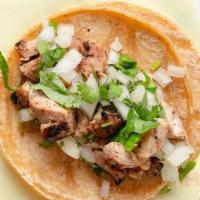 Pollo Asado Taco · Fire grilled marinated Chicken. Served on authentically nixtamalized corn tortillas with cil...