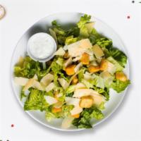 Romaine Dictator Salad · Crispy romaine tosses with croutons, Caesar dressing, and grated cheese.