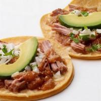Carnitas Taco · Corn tortillas, Pork carnitas, melted Jack cheese, Enchilada sauce, onion-cilantro relish an...